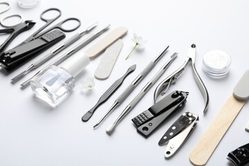 Set of different manicure tools on white background, closeup
