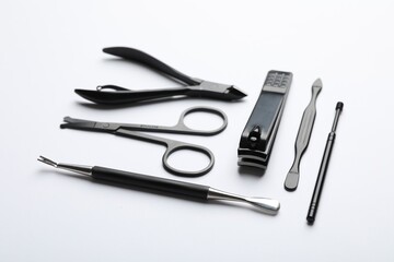 Set of different manicure tools on white background, closeup
