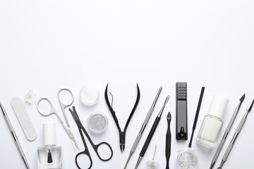 Set of different manicure tools on white background, flat lay. Space for text
