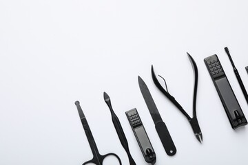 Set of different manicure tools on white background, flat lay. Space for text