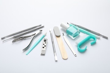 Set of different manicure tools on white background, closeup