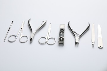 Set of different manicure tools on white background, closeup