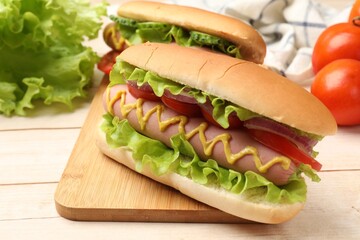 Tasty hot dogs on wooden table, closeup