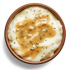 A bowl of creamy mashed potatoes with gravy. Featuring classic comfort food