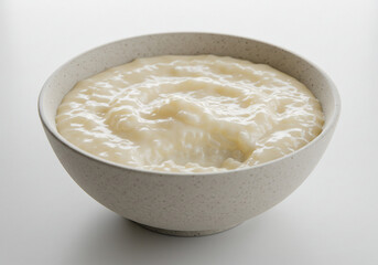 Creamy Rice Pudding in Off White Bowl on White Background