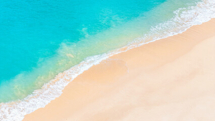 Crystal clear turquoise ocean waves caressing the soft white sand of a tropical beach.