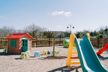 Colorful playground in the park with toy furniture and fairy house