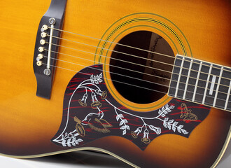 Musical instrument - Closeup fragment vintage pickguard bird acoustic guitar