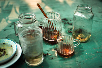 Unclean glass and water bottle on a wooden table