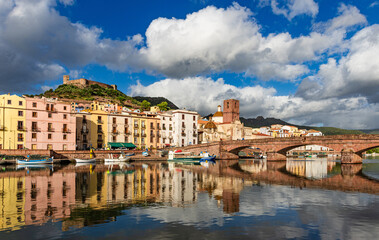 Bosa, Sardinia, Italy - View over the river Temo to the Ponte Vecchio bridge and the historic old town of Bosa with the castle of Serravalle in the background.