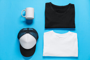 Different blank items for branding on light blue background, flat lay. Mockup for design