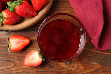 Delicious strawberry sauce and fresh berries on wooden table, flat lay
