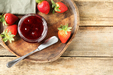 Delicious strawberry sauce and fresh berries on wooden table, flat lay. Space for text