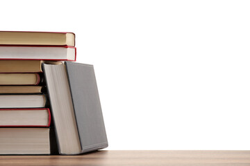 Many old books on wooden table against white background