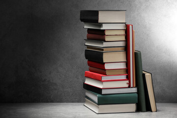 Old books on light grey table, space for text