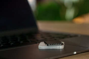 SD memory card, holder and laptop on table, closeup