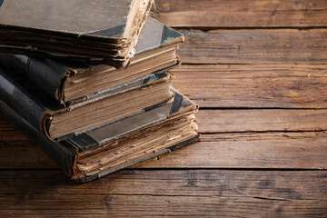 Many old books on wooden table, closeup. Space for text