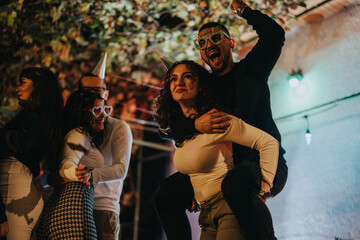 A vibrant moment of friends joyfully celebrating a birthday outdoors during nighttime. The scene is...