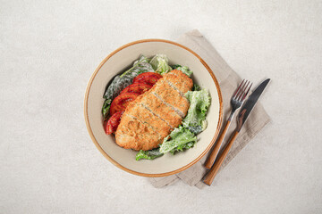 Portion of chicken schnitzel with fresh vegetables