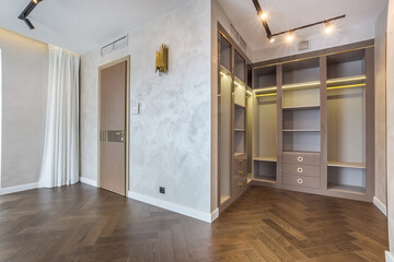 The bright and spacious room is decorated in a modern minimalist style with an elegant layout.  A well-organized walk-in closet with plenty of storage space.