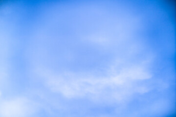 Clear blue sky with soft clouds on a sunny day