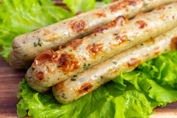 Grilled sausage with herbs served on fresh lettuce leaves