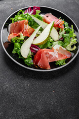 Salad pear ham vegetable dish fresh tasty gourmet food background on the table rustic food top view copy space