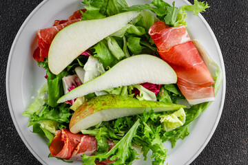 Salad pear ham vegetable dish fresh tasty gourmet food background on the table rustic food top view copy space