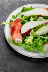 Salad pear ham vegetable dish fresh tasty gourmet food background on the table rustic food top view copy space