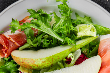 Salad pear ham vegetable dish fresh tasty gourmet food background on the table rustic food top view copy space