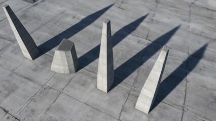 Concrete slabs of geometric design in an urban setting, with shadows on a grey surface.