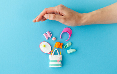A hand is holding a bag with a pink and white striped design and a pink