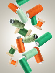 Spools of colorful sewing threads falling on light grey gradient background