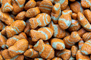 Fish Shaped Dry Pet Food. Close-Up of Colorful Fish-Shaped. Dry Cat or Dog Food Background