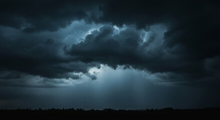 Obraz premium A dramatic storm sky, heavy dark clouds parting to reveal beams of ethereal light piercing the gloom, creating a breathtaking contrast of shadow and illumination.