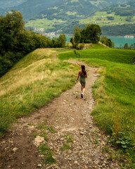 Young , beautiful caucasian woman hiking in Switzerland mountains,