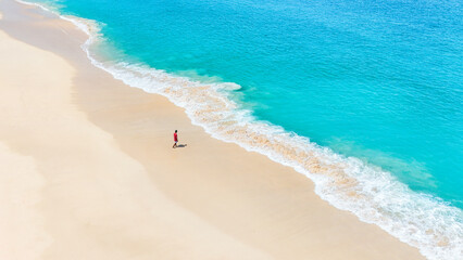 Relaxing coastal view of white sand beach and clear turquoise water. summer background and summer holiday concept.