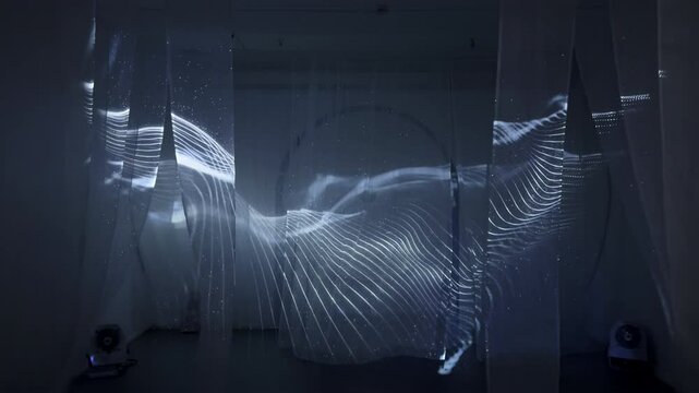 Light patterns projected on fabric in dark room. Action