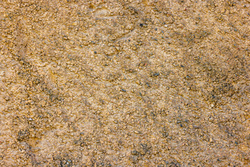 rugged beige concrete wall texture with pebbles