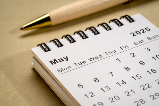 May 2025 - small spiral desktop calendar, time and business concept