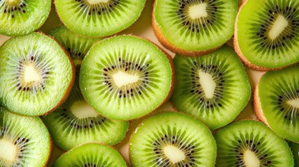 Thinly sliced kiwi pieces placed on a neutral background, emphasizing their vibrant color contrast and juicy texture.