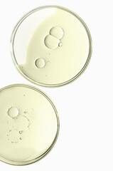 The texture of a cosmetic serum or body gel in a Petri dish.