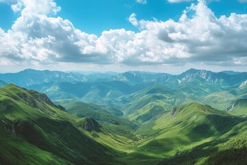 Obraz premium Beautiful green mountain landscape under a partly cloudy blue sky