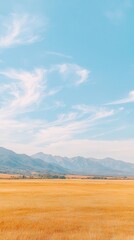 Obraz premium Picturesque Landscape: Serene Mountains, Fields, and Sky