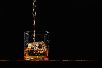 Bourbon in a glass on old wood table