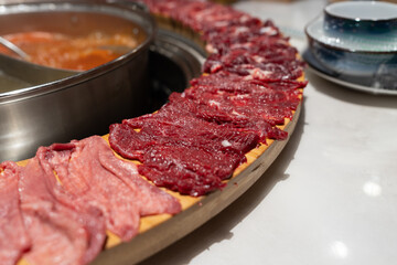 Thinly sliced beef and pork ready for a perfect hotpot dip