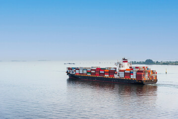 Fully loaded cargo container ship departing from port of Tanjung Pelepas on her international trade...