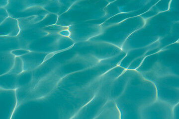 water in the pool sparkles in the sunlight, background	