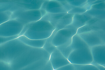 water in the pool sparkles in the sunlight, background