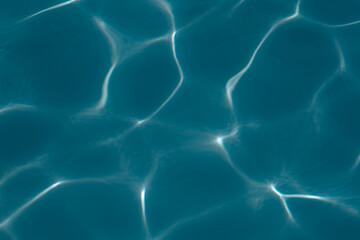 water in the pool sparkles in the sunlight, background	